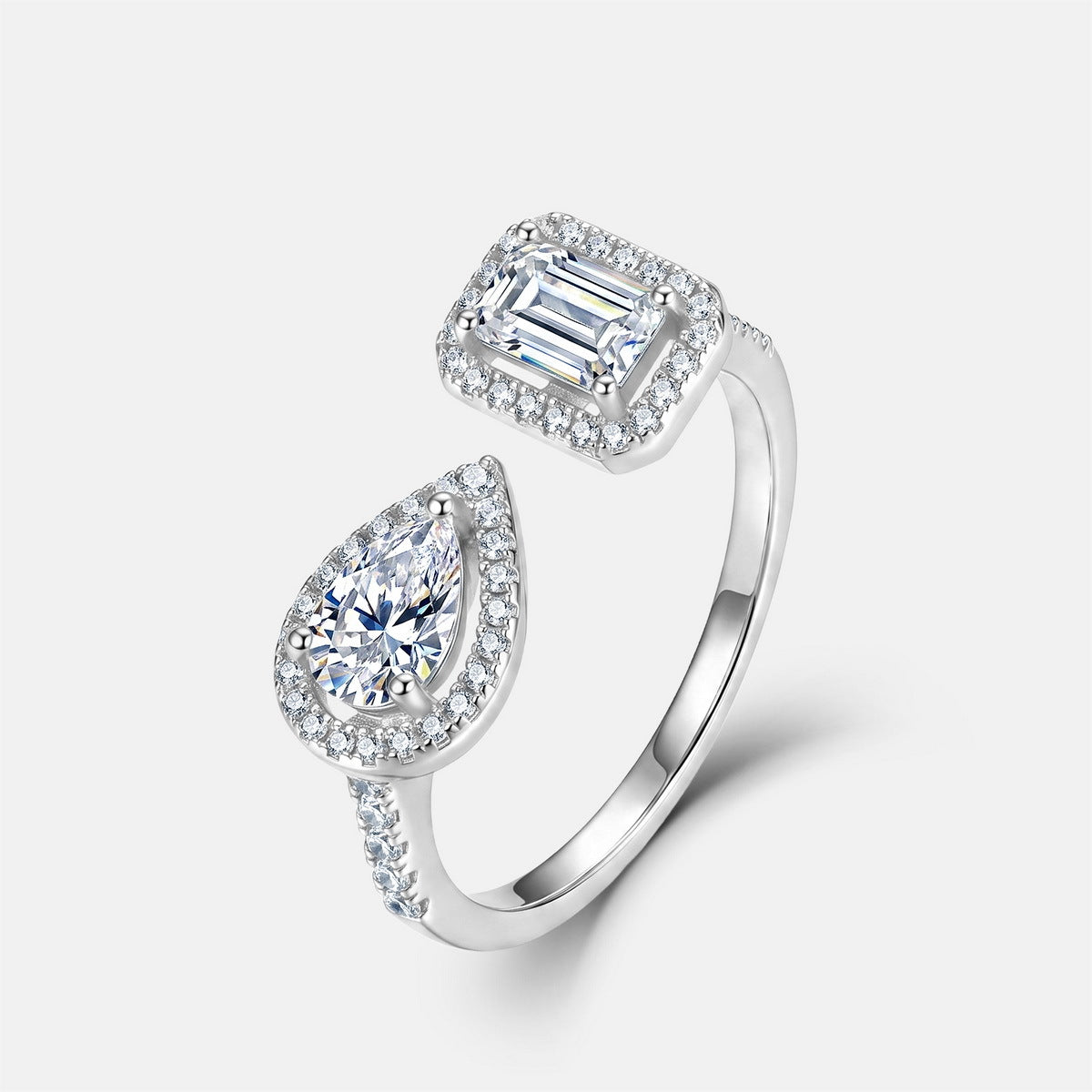 Emerald and pear cut lab grown diamond toi et moi open cuff ring in sterling silver isolated on white background