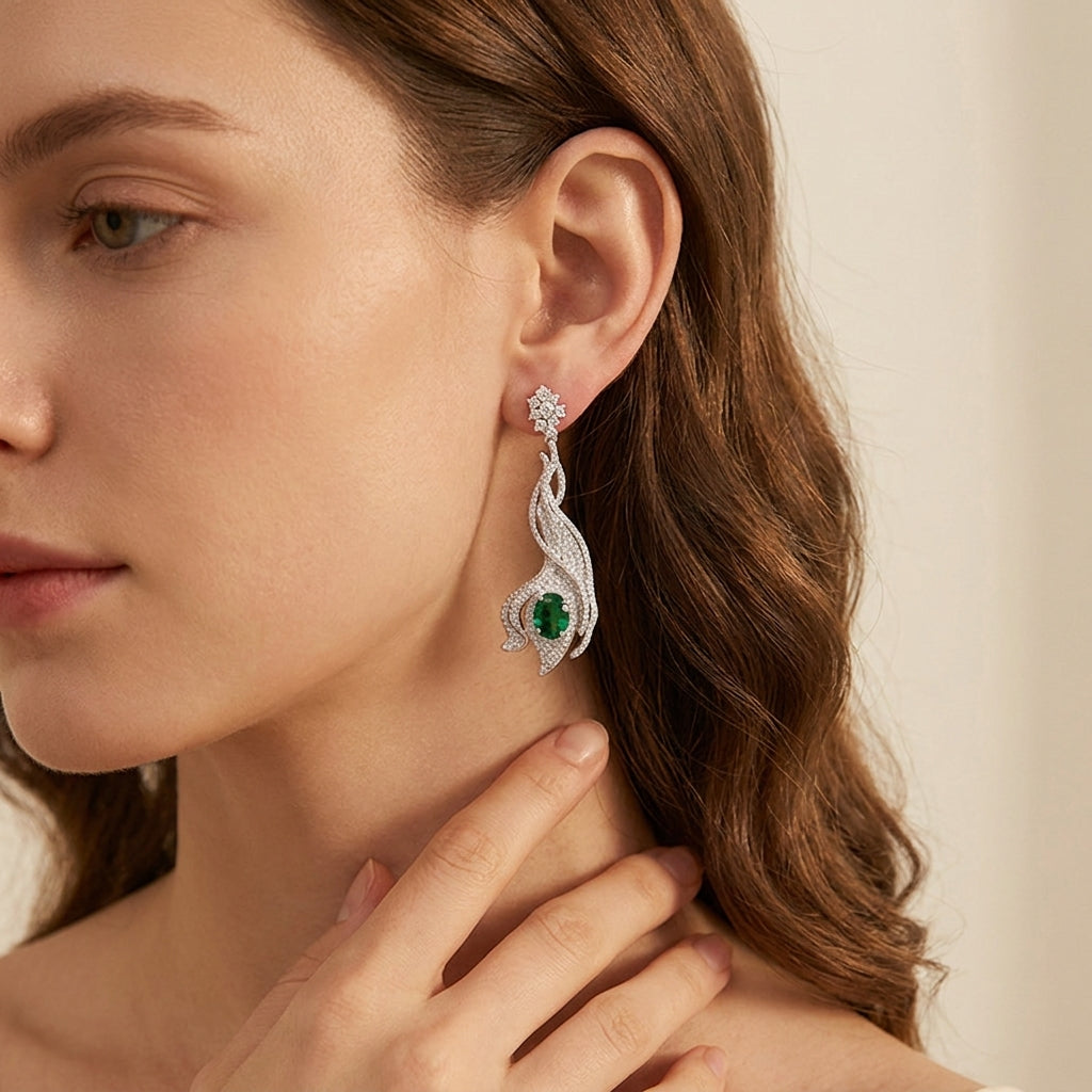 Model wearing 3.14ct oval emerald wave earrings, side profile, elegant hair look.