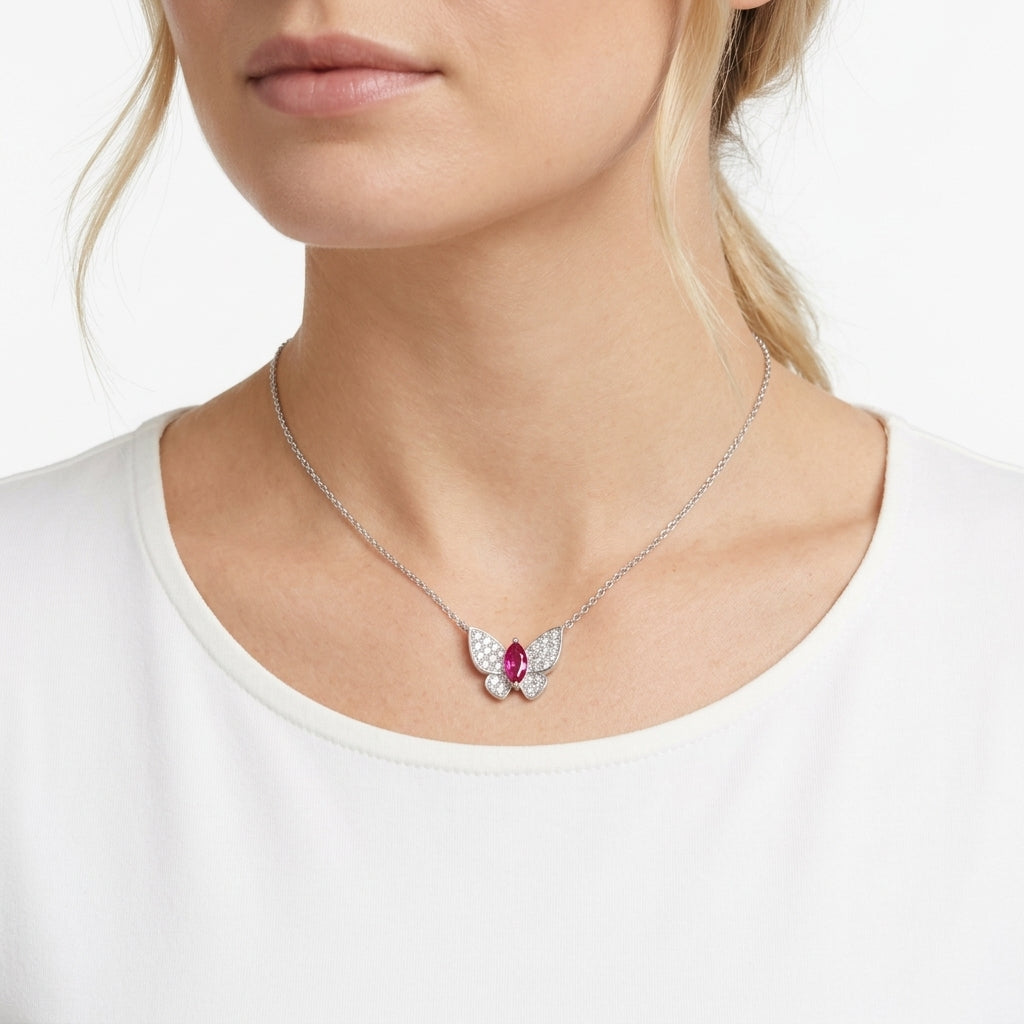 Far shot view of a model showcasing an ethereal ruby butterfly statement pendant necklace on her collarbone.