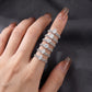 Hand displaying various solitaire and pave stacking ring sets in fancy cuts.