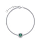 Overhead circular display view of a fine jewelry cushion-cut emerald halo tennis bracelet on a white backdrop.