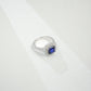 Macro close-up product view of a fine jewelry sapphire double halo ring with a diamond encrusted split-shank pave band.