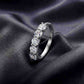 Angled perspective shot of five-stone round brilliant lab grown diamond ring on dark silk.
