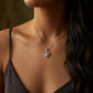 Model wearing round diamond floating heart solitaire pendant necklace with black camisole.