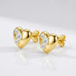 Studio macro close-up highlighting 3D metallic puffy heart surface and precision prong-set diagonal moissanite accents.