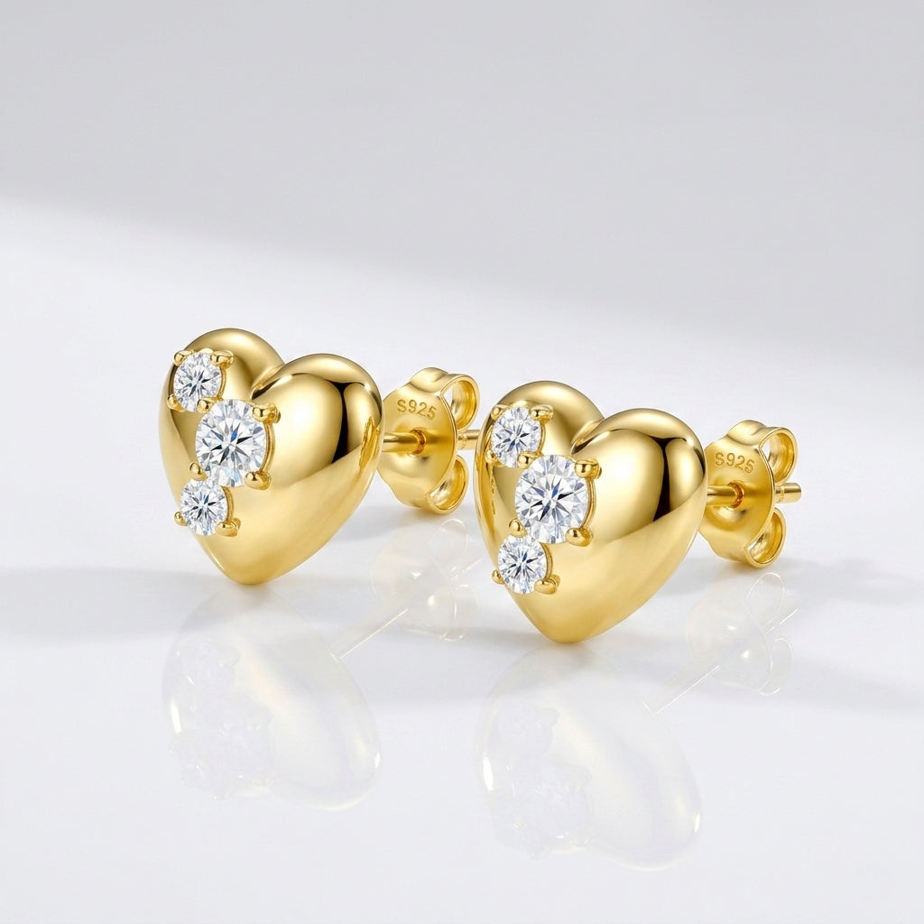 Studio macro close-up highlighting 3D metallic puffy heart surface and precision prong-set diagonal moissanite accents.