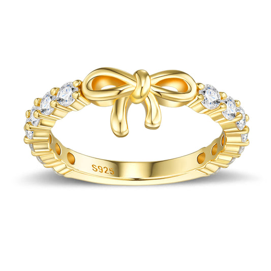 Gold bow knot ribbon half eternity stacking ring in 925 sterling silver, front view with sparkling stones.