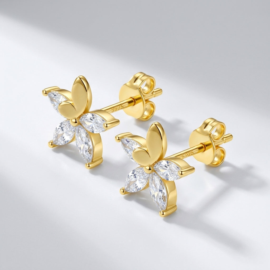 Studio macro close-up view highlighting 3D gold butterfly crest and precision prong-set marquise moissanite petal array.