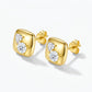 Studio macro close-up view highlighting sculpted gold cushion square frame set with heart and round moissanite stones.
