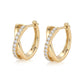 Pair of gold crisscross X pavé moissanite huggie hoops showing snap-hinge closure.