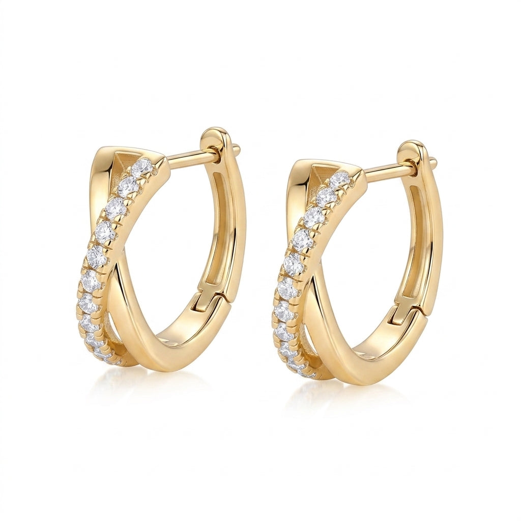 Pair of gold crisscross X pavé moissanite huggie hoops showing snap-hinge closure.
