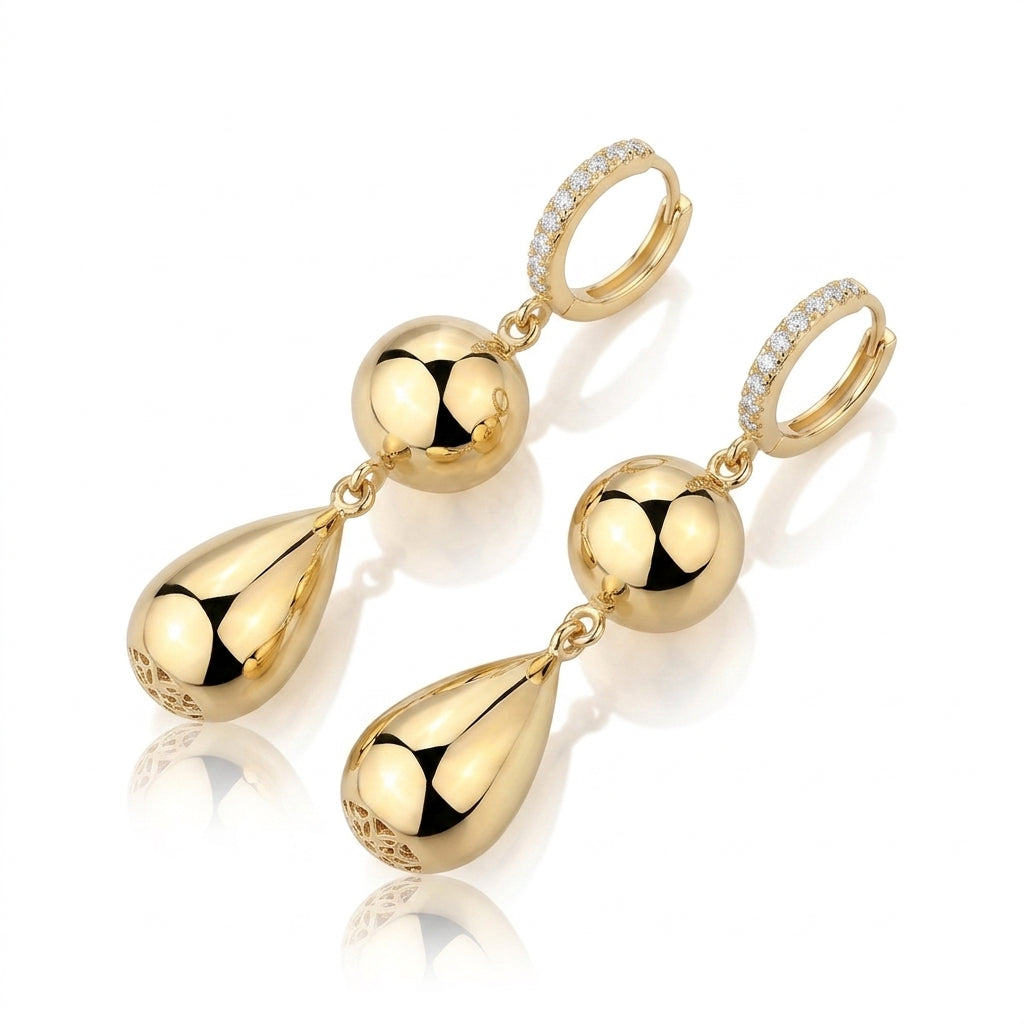 Pair of gold double drop sphere and teardrop moissanite huggie hoop earrings angled view.
