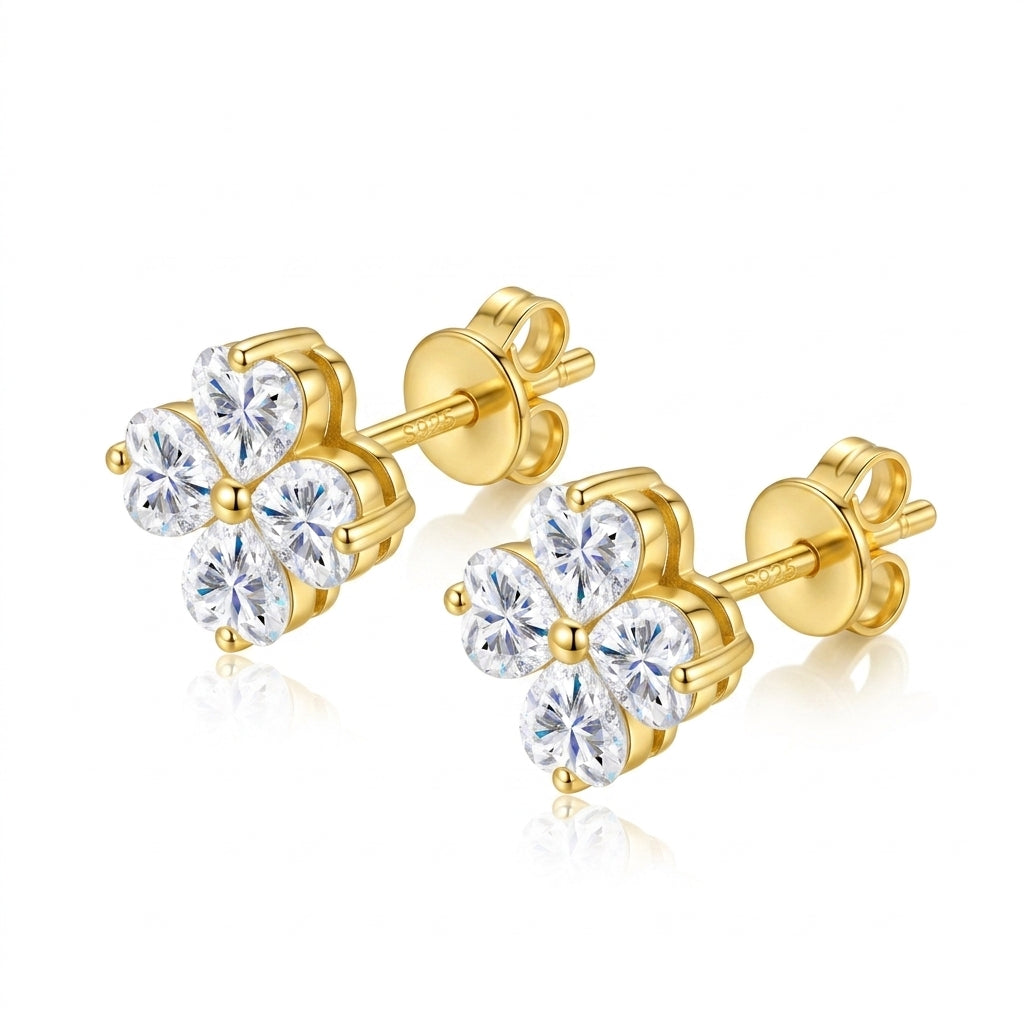 Angled studio view showing secure push-back post, golden prongs, and heart-shaped moissanite clover design.