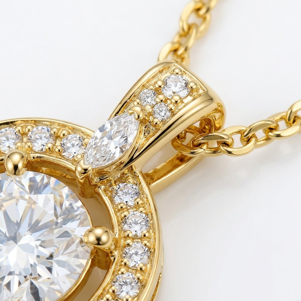 Macro close-up showing micro-pavé halo setting and marquise moissanite accent bail on gold pendant.
