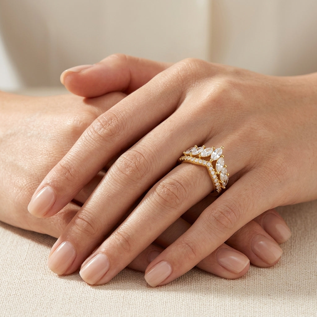 Close-up view of a model wearing gold marquise moissanite crown chevron stacking ring on hand.