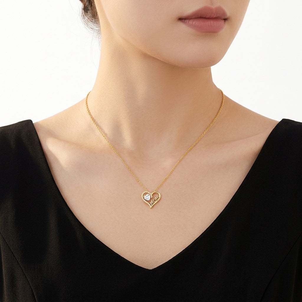 Close-up view of a woman wearing the gold MOM heart gemstone pendant necklace.