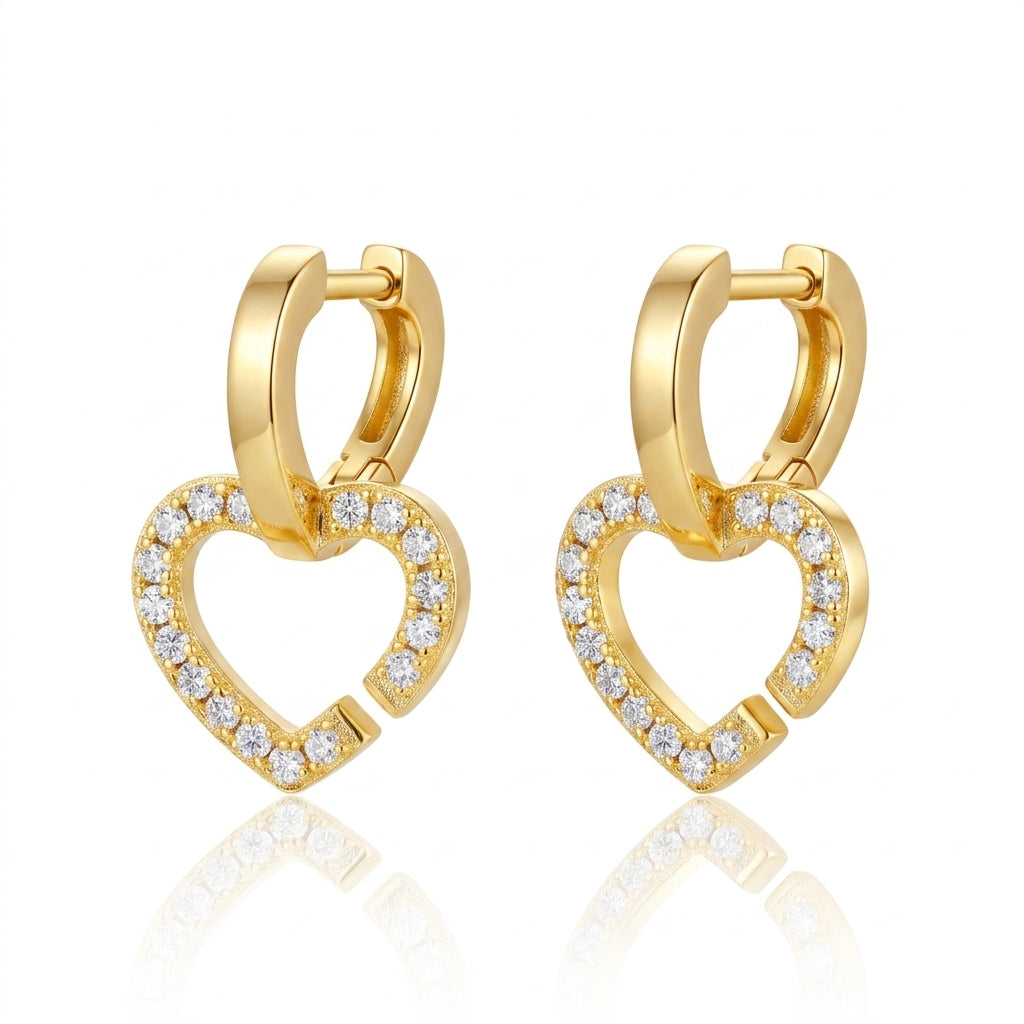 Pair of gold heart shaped huggie hoops with dangling pavé moissanite heart charms.