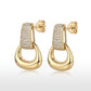 Pair of gold pavé moissanite stirrup door knocker earrings showing post back closure.