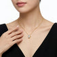 Model wearing gold pear cut moissanite butterfly charm necklace.