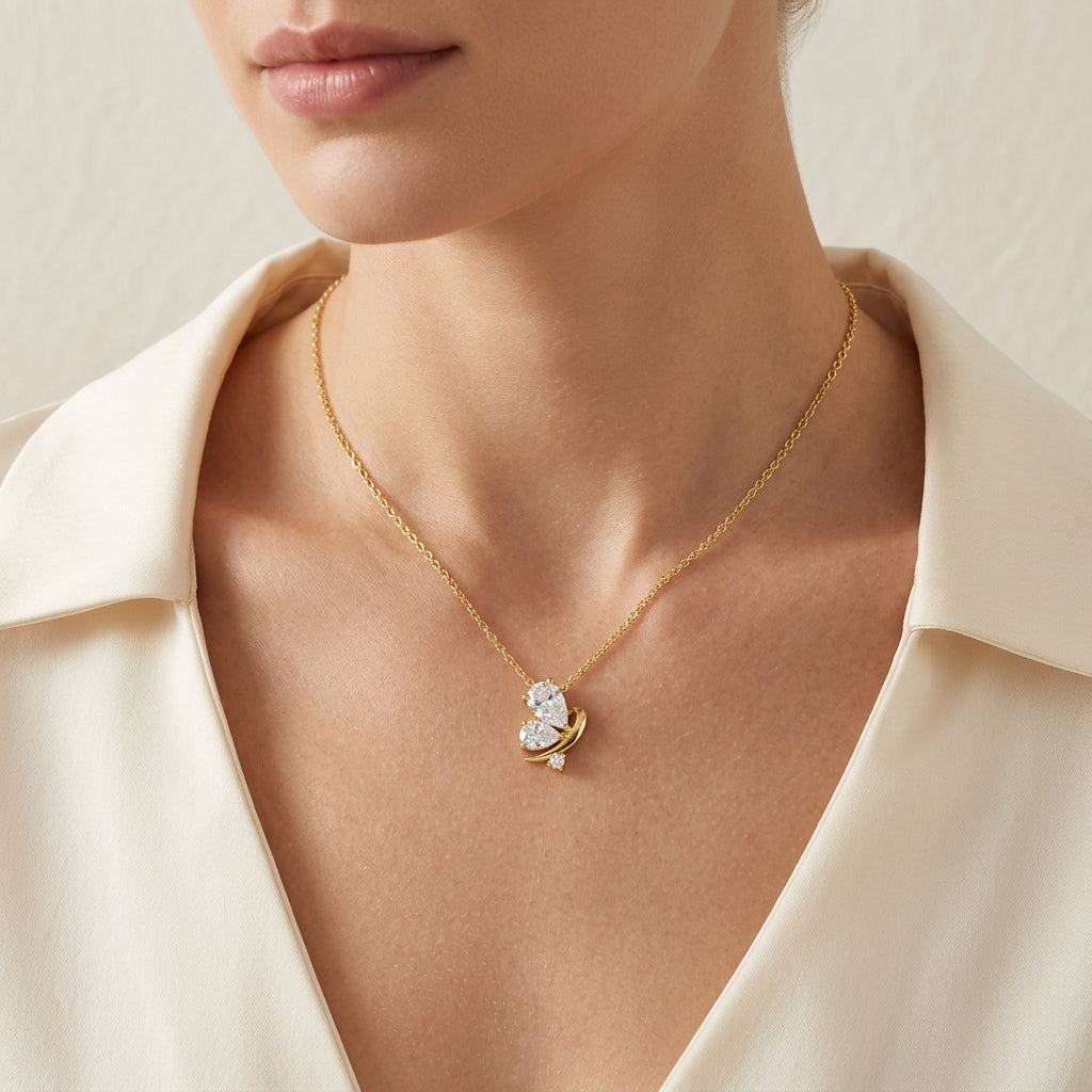 Close-up view of a model wearing classic gold teardrop butterfly moissanite pendant necklace.