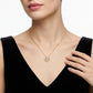Model wearing gold round moissanite starburst circle disc pendant necklace.