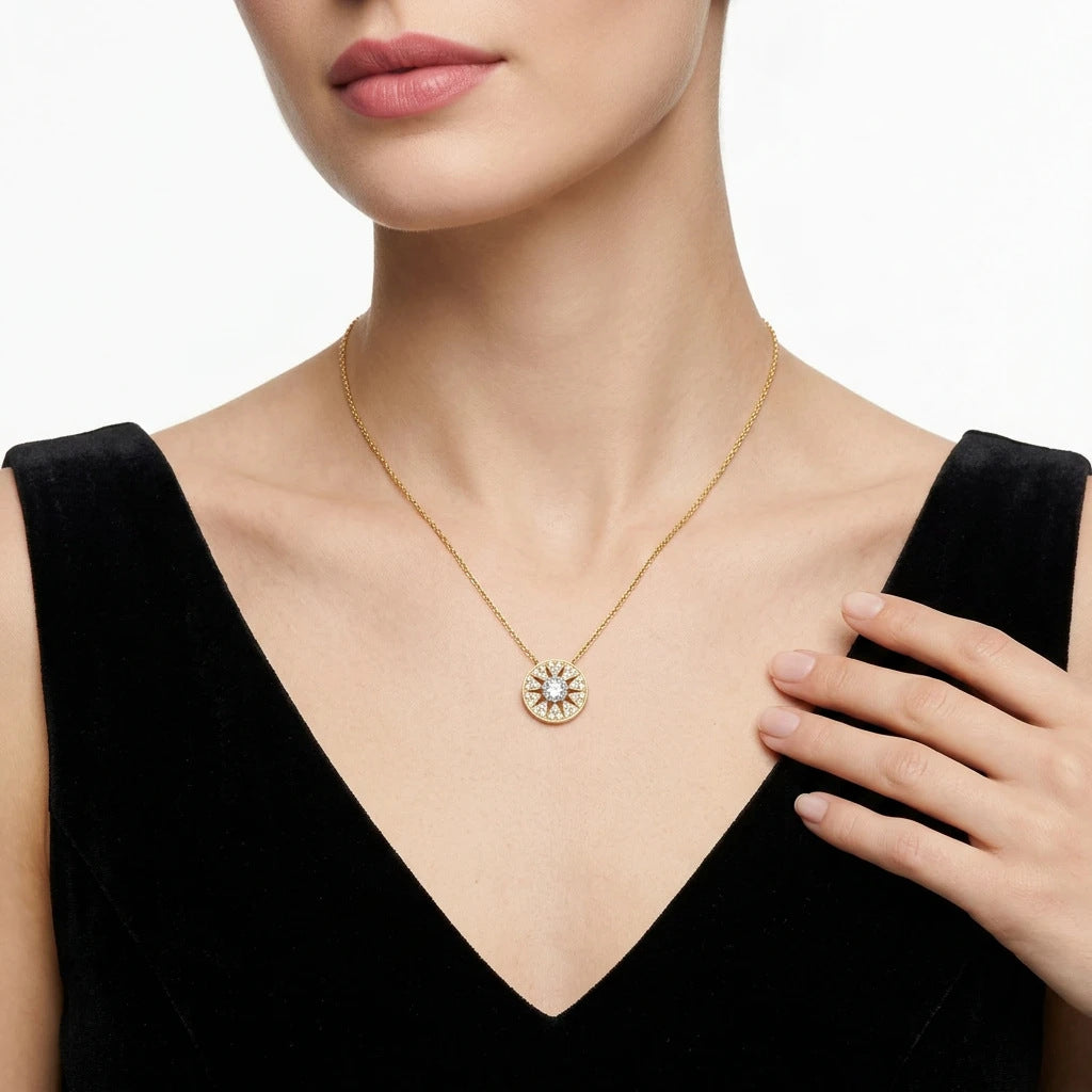 Model wearing gold round moissanite starburst circle disc pendant necklace.