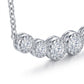 Close-up view of full bezel set graduated moissanite curved bar pendant.
