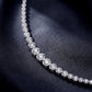 Curved link profile of graduated bezel round lab-grown diamond tennis bracelet.