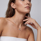 Model wearing graduated moissanite trio square drop pendant necklace on collarbone.