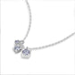 Perspective view of graduated moissanite trio square drop pendant necklace on white background.