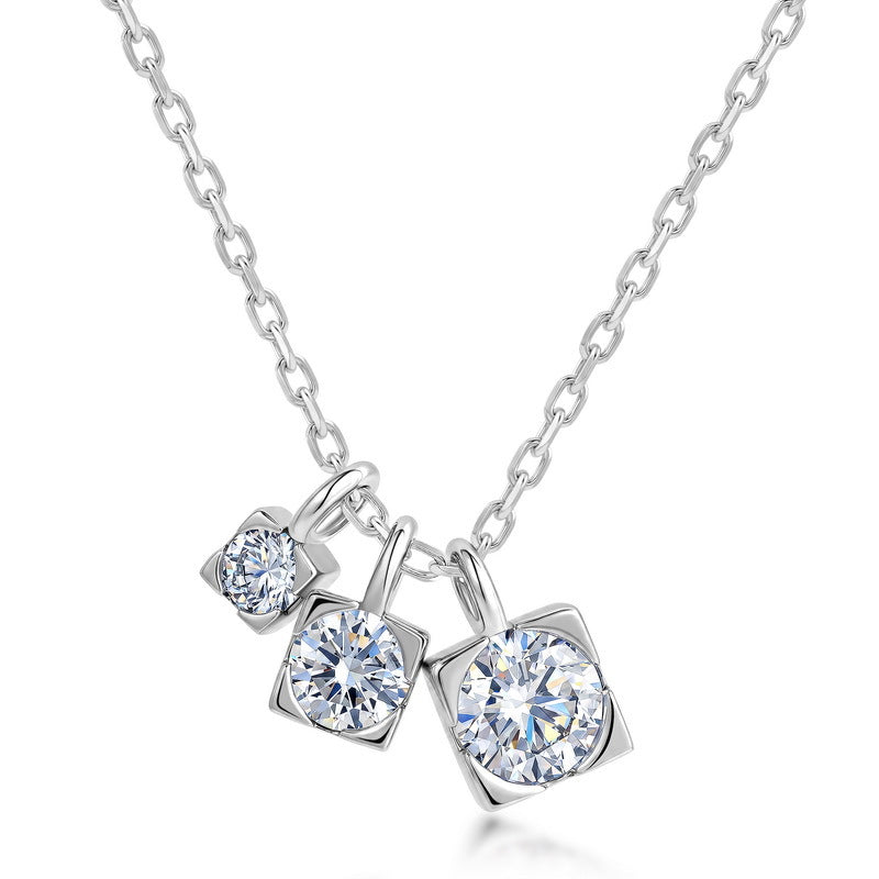 Graduated moissanite trio square drop pendant necklace with three charms on cable chain in sterling silver.
