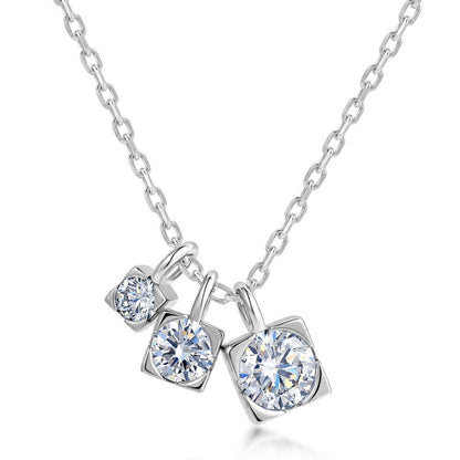 Graduated moissanite trio square drop pendant necklace with three charms on cable chain in sterling silver.