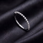 Side profile view of delicate half eternity lab grown diamond band ring on black silk