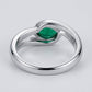 Studio product view focusing on the sleek gallery profile and inner band of a handcrafted bezel-set emerald solitaire ring.