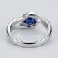 Studio product view focusing on the sleek gallery profile and inner band of a handcrafted bezel-set blue sapphire solitaire ring.