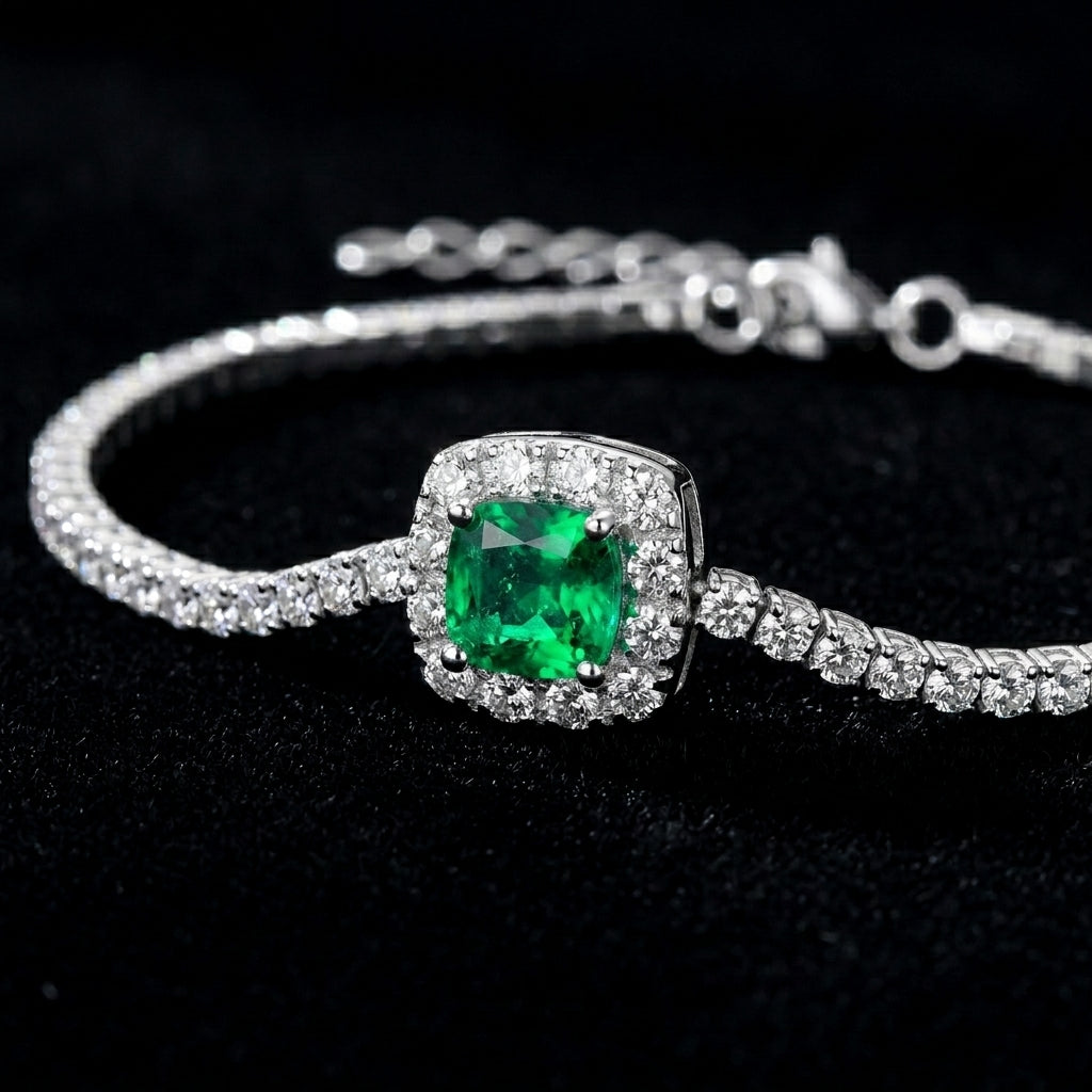 Dark black background close-up product view of a handcrafted pave diamond emerald tennis chain bracelet.