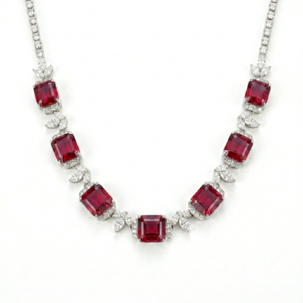 Studio white background shot showcasing a handcrafted princess-cut ruby cluster collar necklace with pave diamond links.
