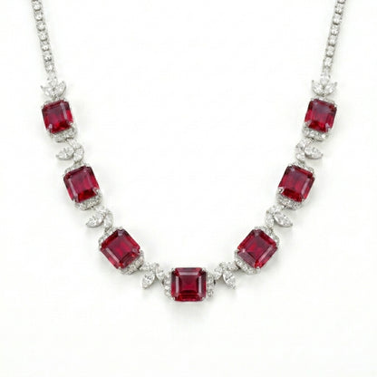 Studio white background shot showcasing a handcrafted princess-cut ruby cluster collar necklace with pave diamond links.