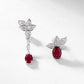 Diagonal studio shot of handcrafted ruby botanical mismatched earrings casting a soft gradient shadow.