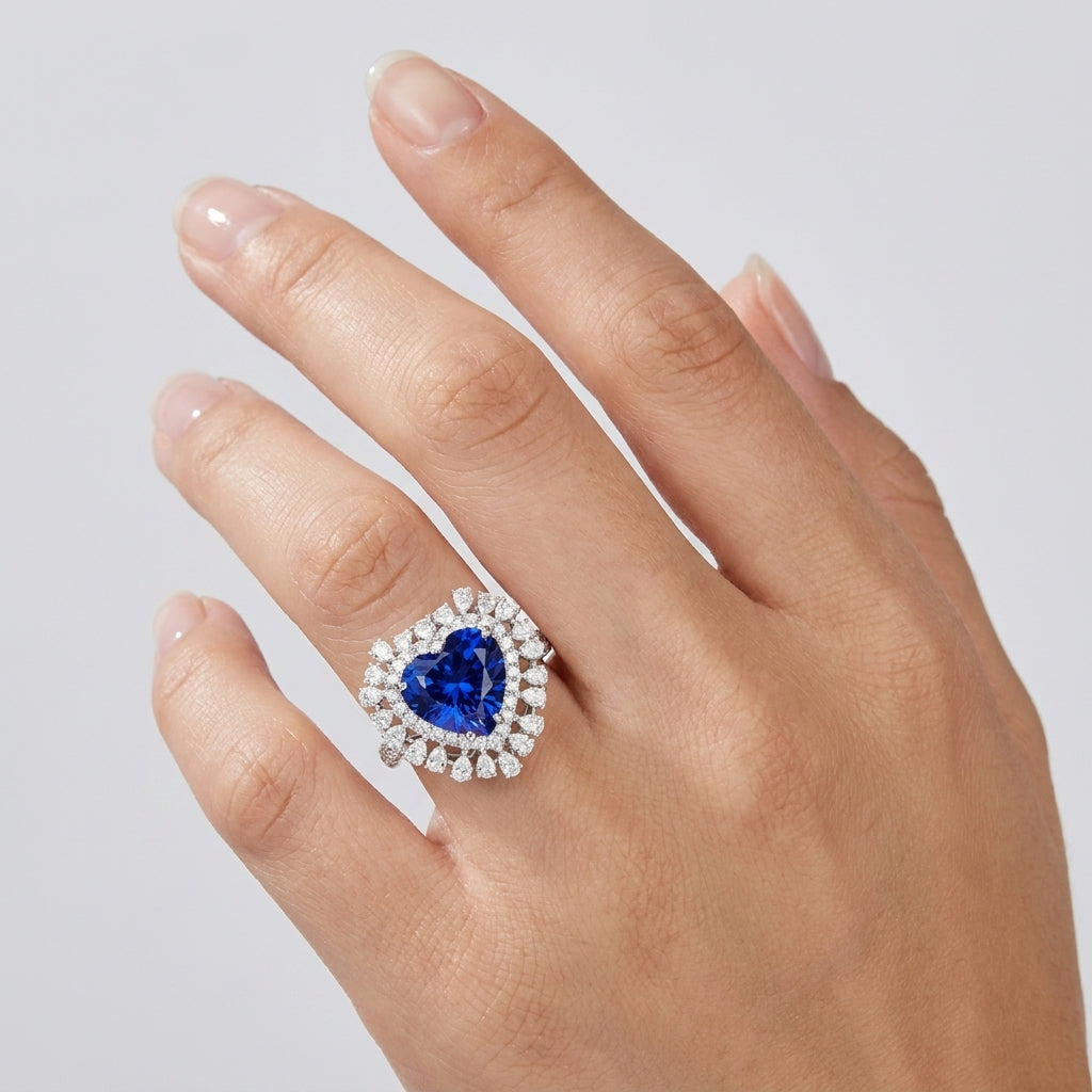 Elegant heart blue sapphire halo ring worn on hand, featuring minimalist vintage aesthetic