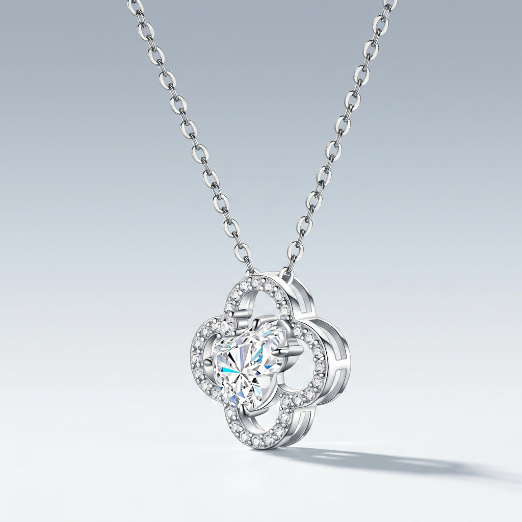 Perspective view of heart shaped moissanite openwork gourd clover pendant necklace on slate.