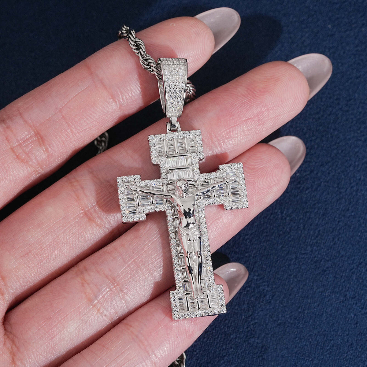 Hand holding S925 sterling silver full iced out moissanite baguette crucifix cross hip hop pendant