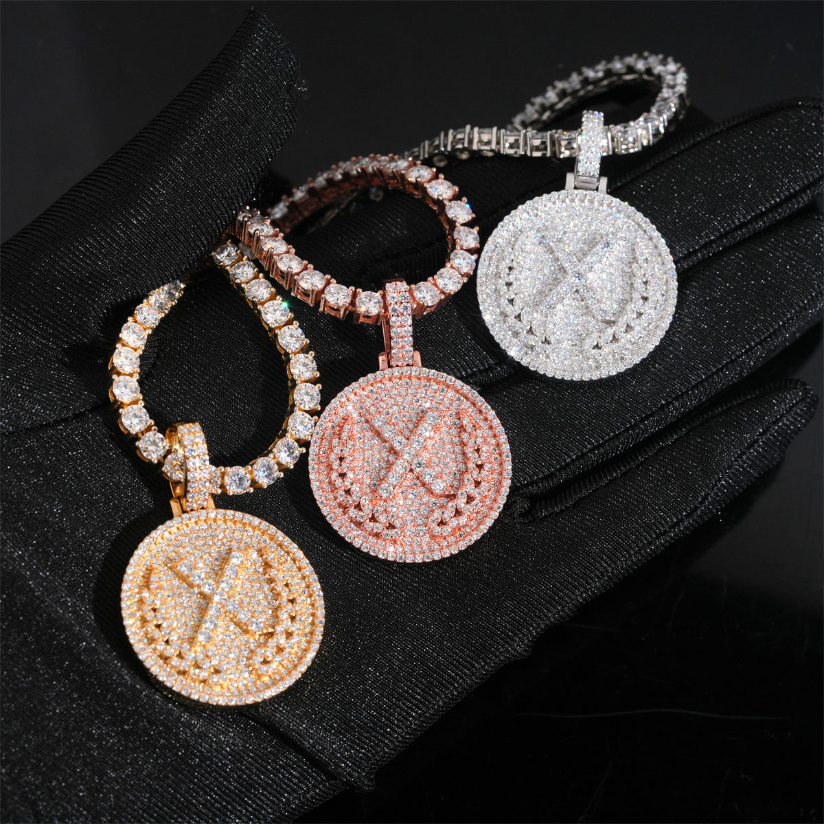 Hand wearing black glove holding S925 silver iced out moissanite letter X medallion hip hop pendants with chains   