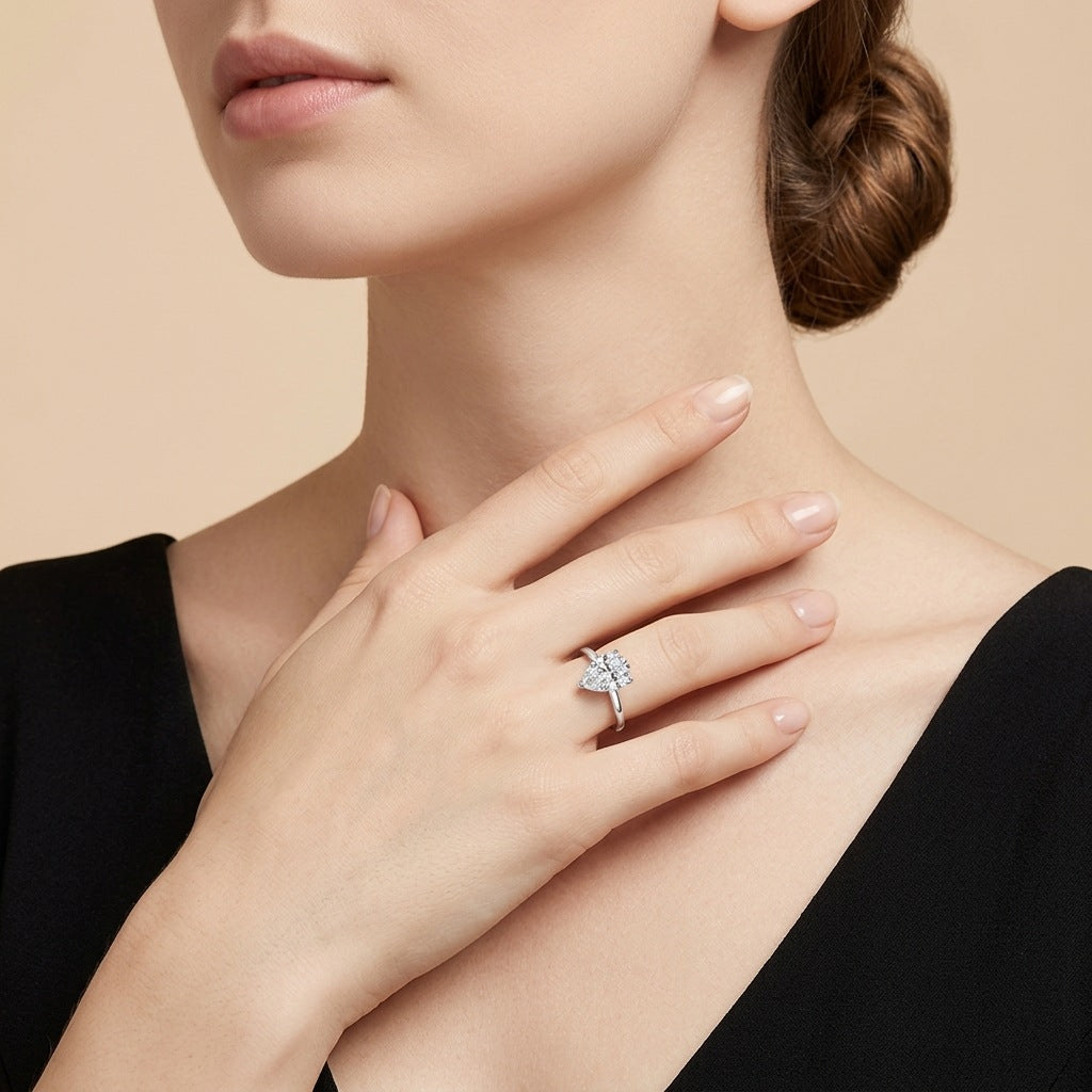 Model wearing the modern horizontal pear cut moissanite teardrop solitaire ring.