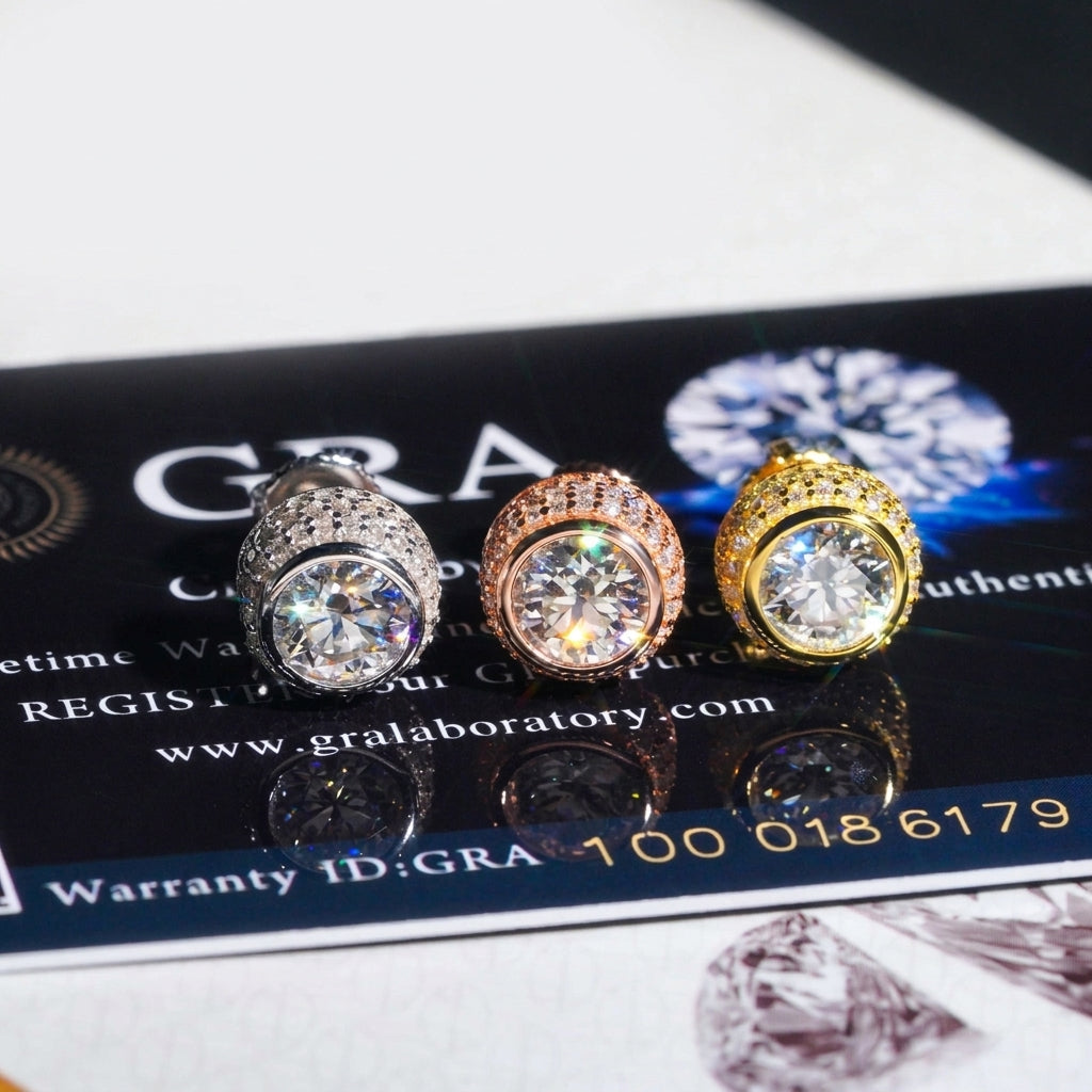 Iced out 3D bezel cylinder solitaire moissanite stud earrings in silver, rose gold, and yellow gold on GRA card
