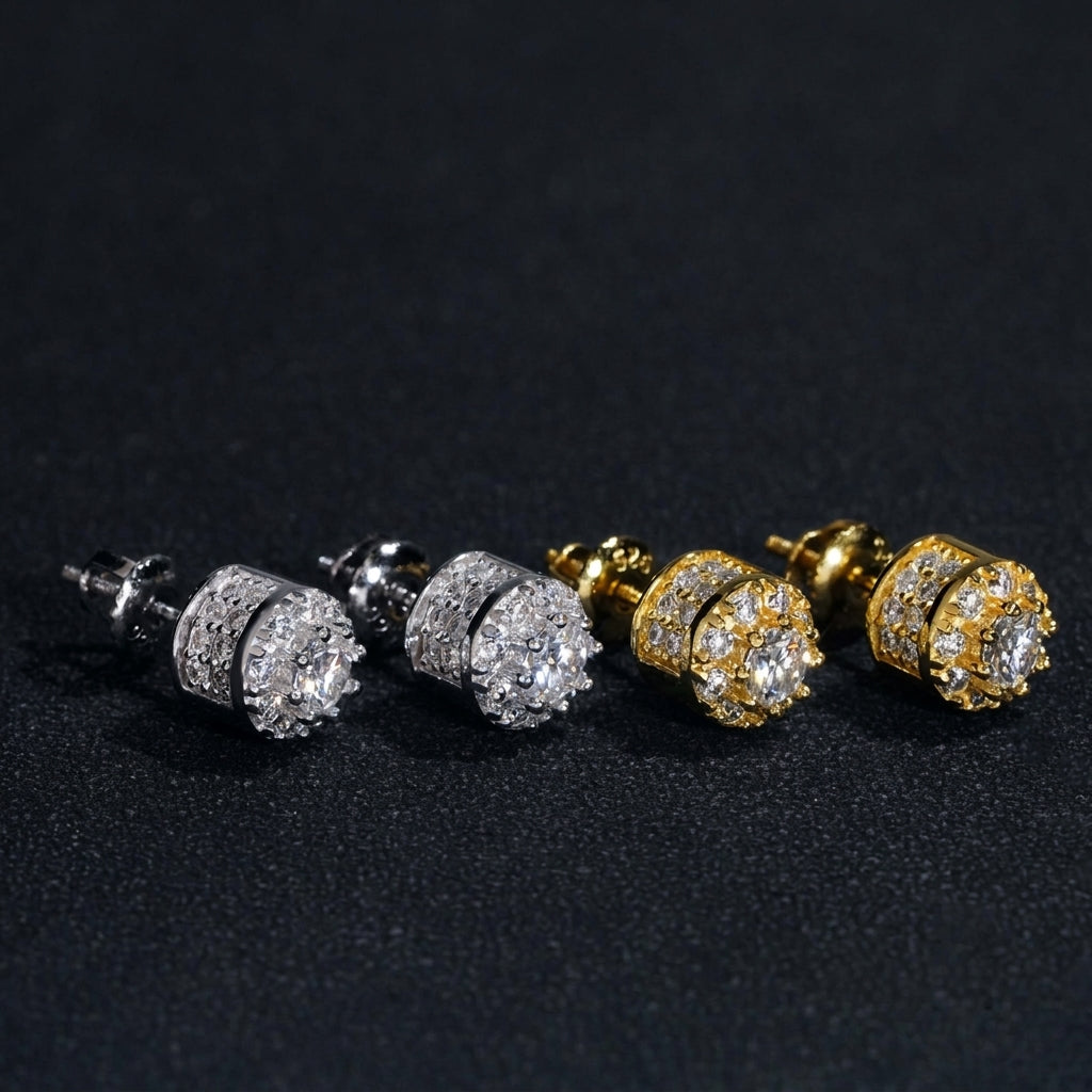 Iced out 3D crown cylinder solitaire moissanite stud earrings in silver and yellow gold on dark background   