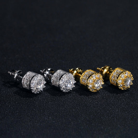 Iced out 3D crown cylinder solitaire moissanite stud earrings in silver and yellow gold on dark background   