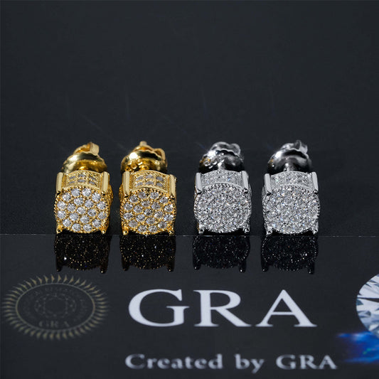 Gold and silver iced out 3D round cylinder moissanite stud earrings displayed on GRA report card