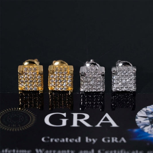 Iced out 3D square block moissanite stud earrings in yellow gold and silver displayed on GRA card