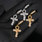Gold and silver iced out ankh cross snake dangle moissanite earrings on gloved hand showing hinged clasp